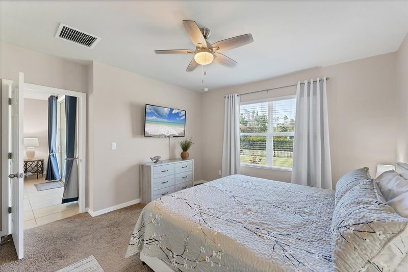 Primary bedroom with king bed and attached bathroom