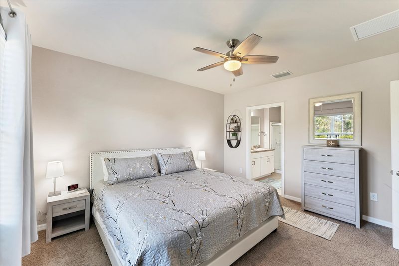 Primary bedroom with king bed and attached bathroom