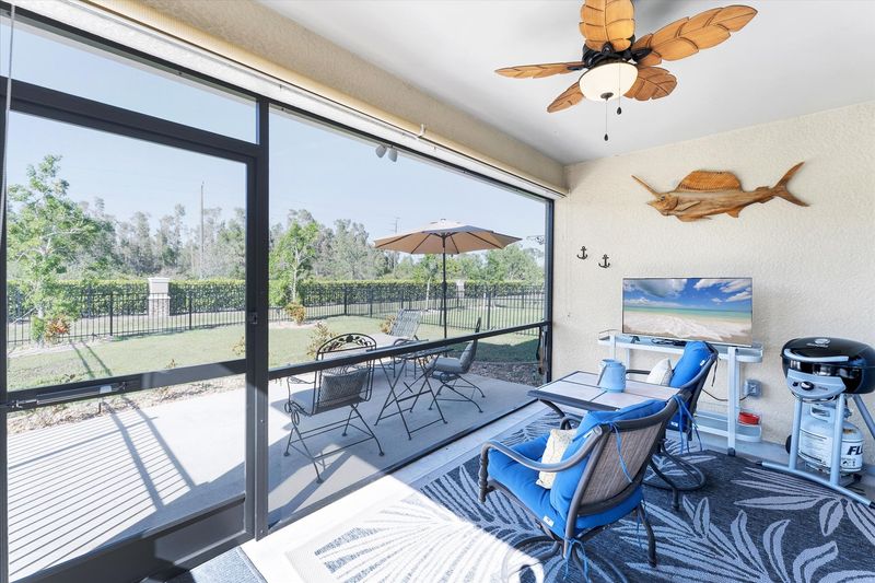 Enclosed patio overlooking fenced backyard