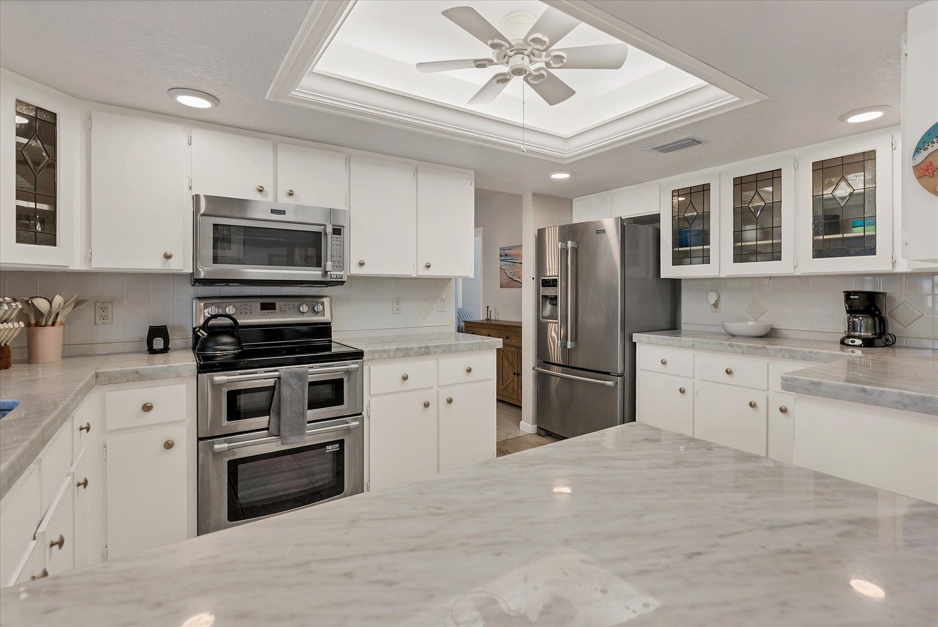 Bright, fully-equipped kitchen with plenty of countertop space and new stainless-steel appliances
