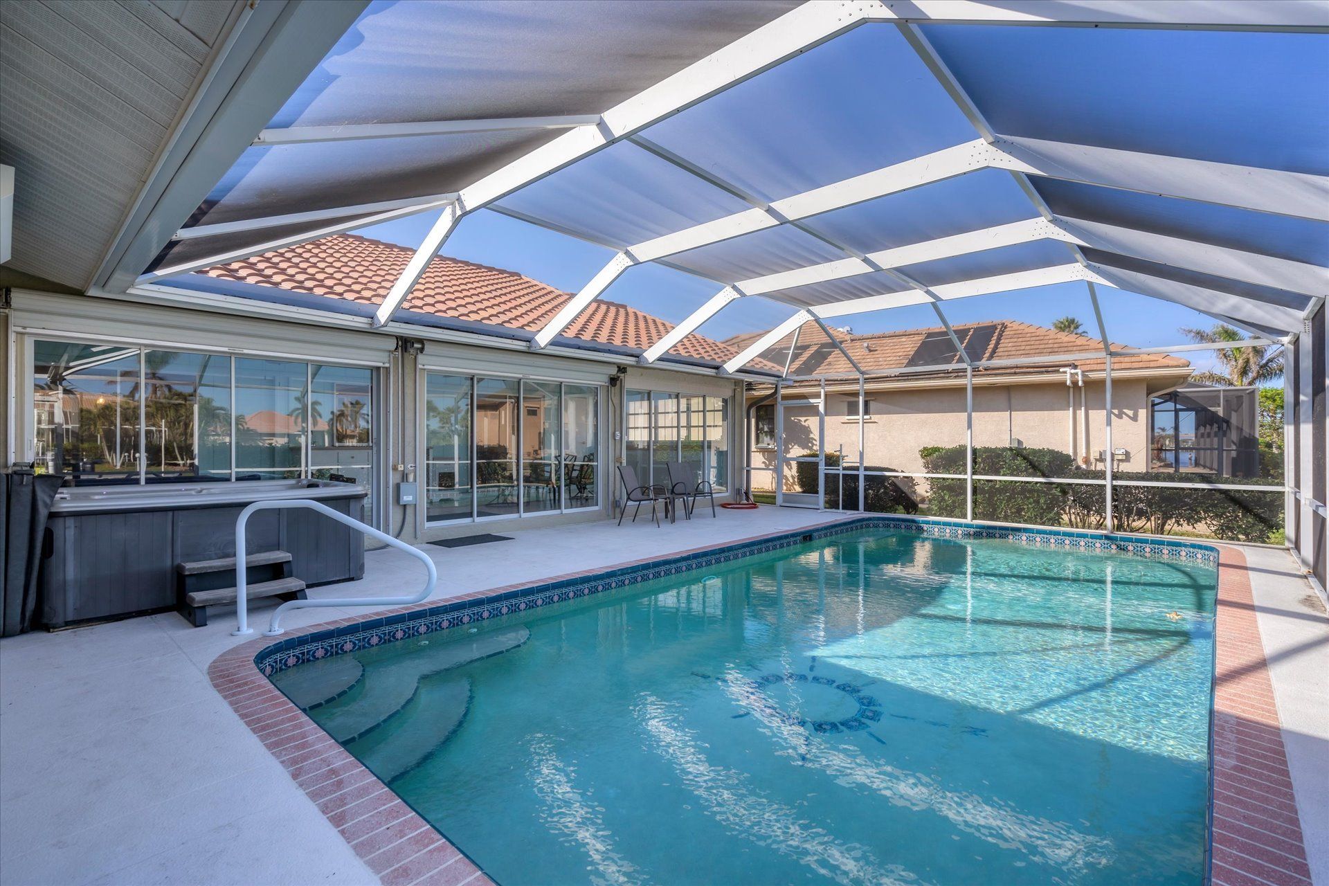 Sparkling pool and hot tub overlooking canal