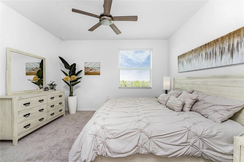 Primary bedroom with king bed and attached bathroom