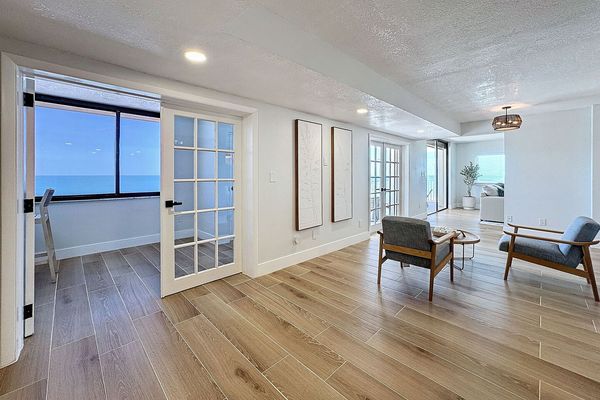 Sitting area and French door opening to the enclosed balcony