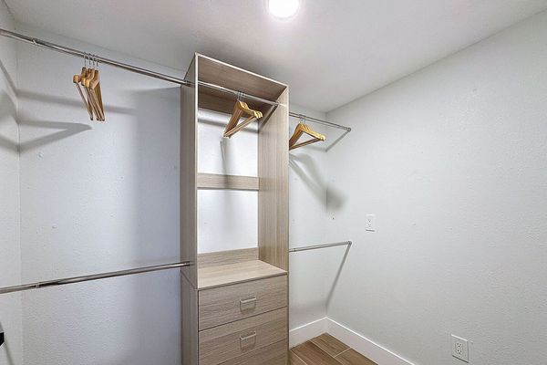 Primary Closet with hanging and drawer storage