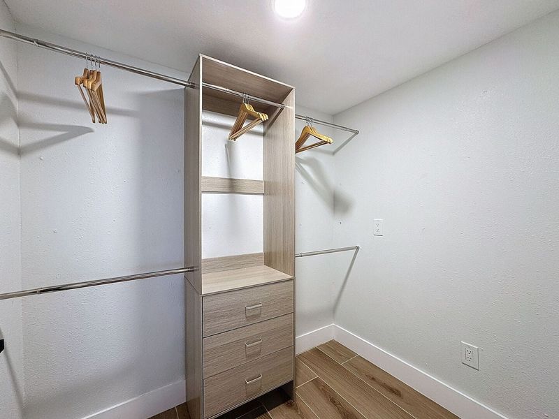 Primary Closet with hanging and drawer storage