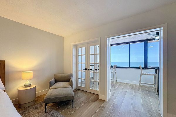 Primary Suite with French Doors leading to the enclosed balcony