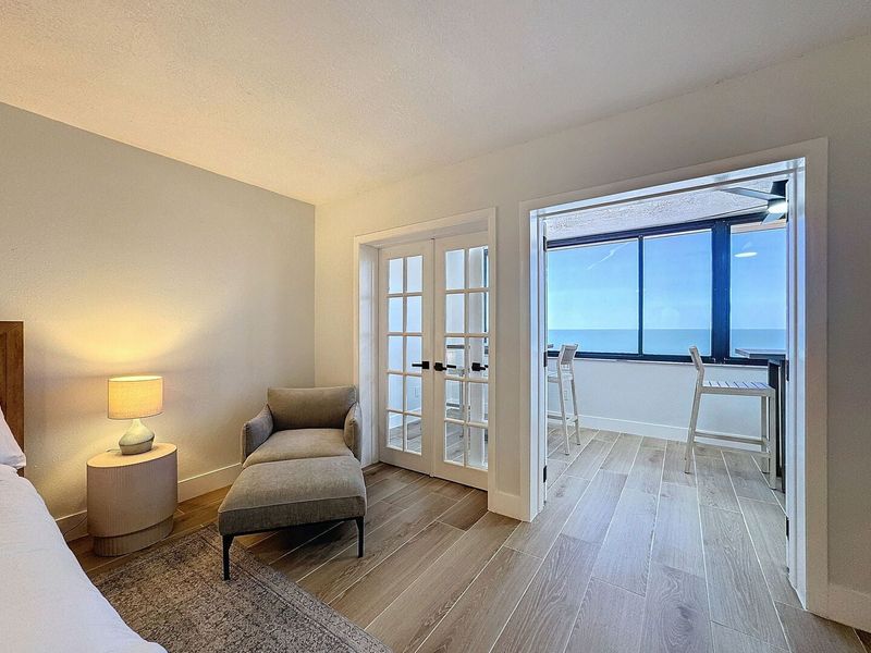 Primary Suite with French Doors leading to the enclosed balcony