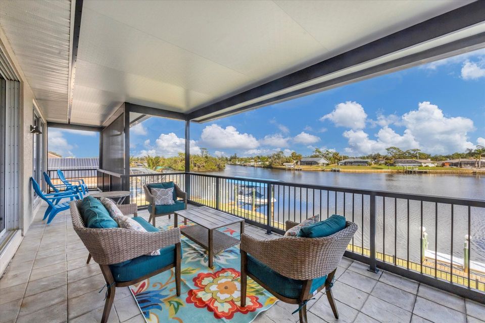 Balcony overlooking pool and water
