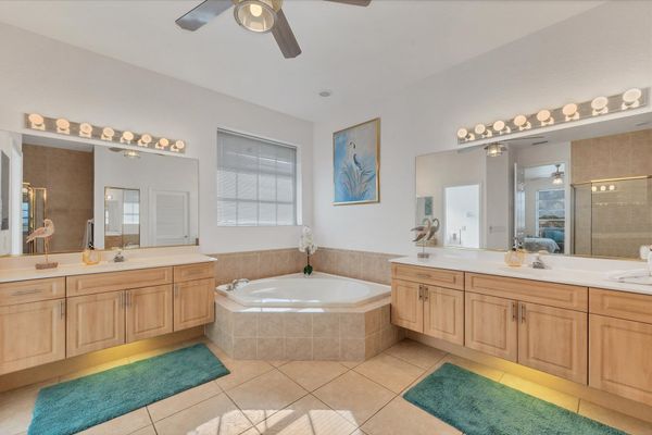 Primary attached bathroom with walk-in shower, garden tub, double vanities and huge walk-in closet