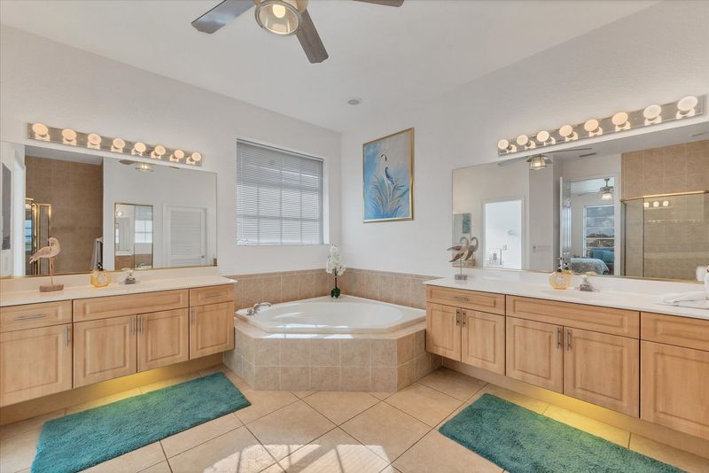 Primary attached bathroom with walk-in shower, garden tub, double vanities and huge walk-in closet