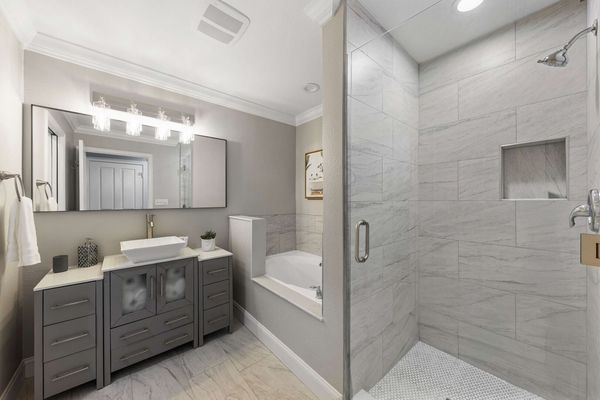 Refresh in the ensuite bath, featuring premium fixtures and a sleek layout