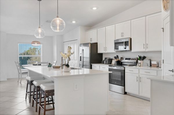 Fully-equipped kitchen over looking living room and dining area