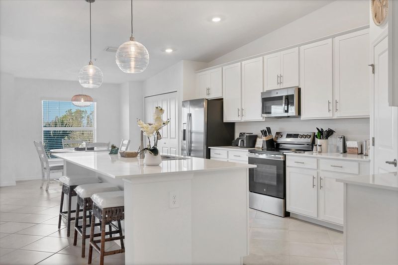 Fully-equipped kitchen over looking living room and dining area