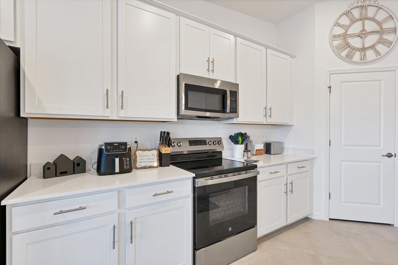 Fully-equipped kitchen over looking living room and dining area