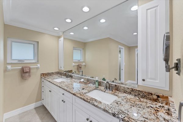 Primary bedroom en suite with walk-in shower and double vanities