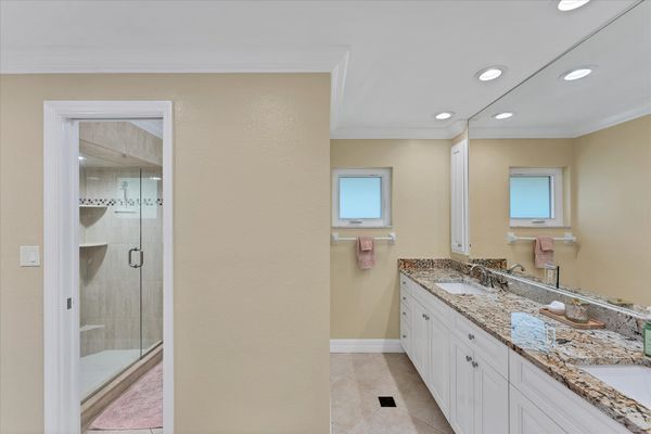 Primary bedroom en suite with walk-in shower and double vanities