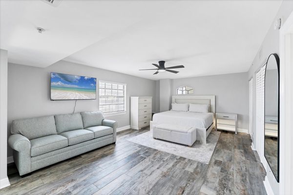 Primary Bedroom With King Bed,  attached bathroom, 50-inch Smart TV, and balcony access