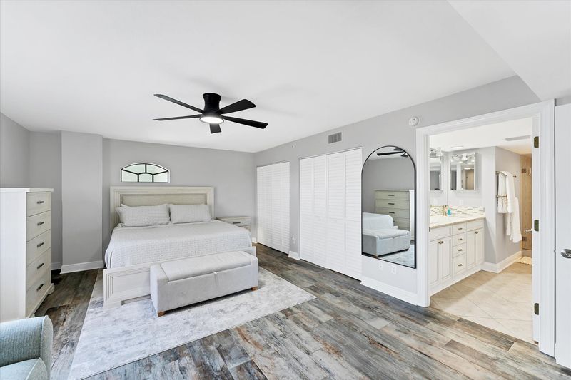 Primary Bedroom With King Bed,  attached bathroom, 50-inch Smart TV, and balcony access