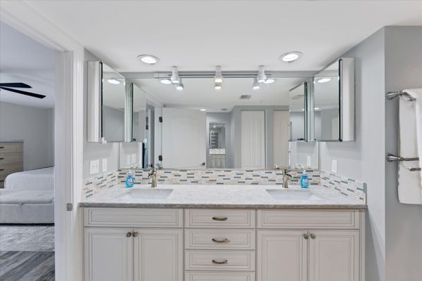 Primary Bathroom With Double Vanities and Walk-In Shower