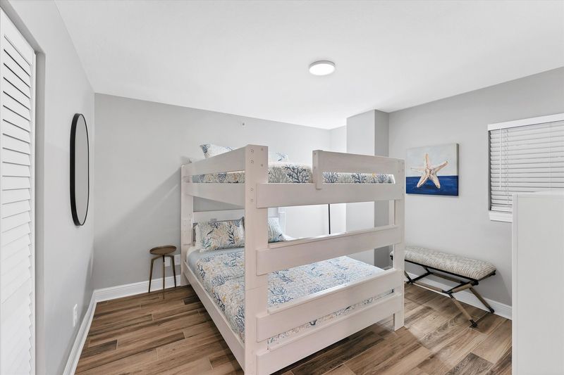 Guest bedroom with a queen over queen bunkbed