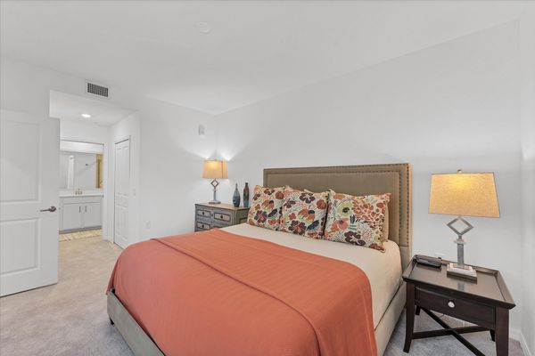 Primary bedroom with king bed and attached bathroom