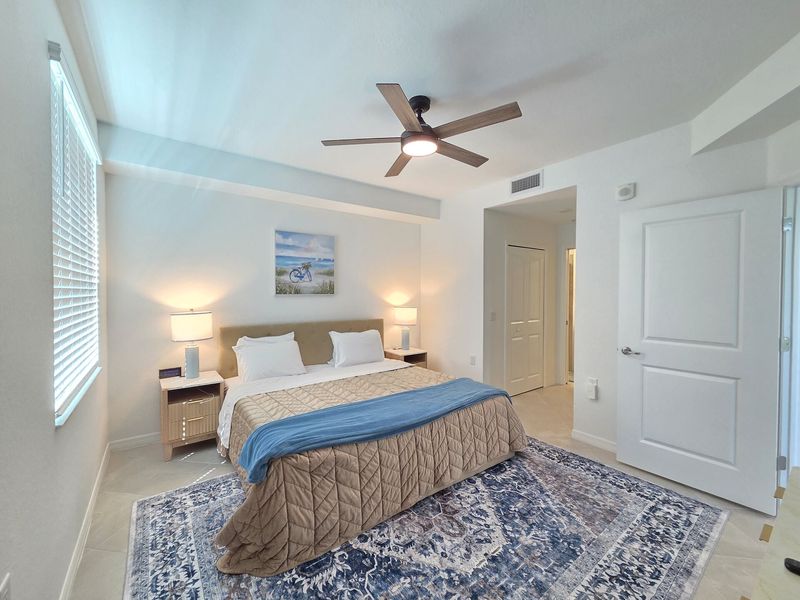 Primary bedroom with king bed, 50-inch Smart TV and attached bathroom