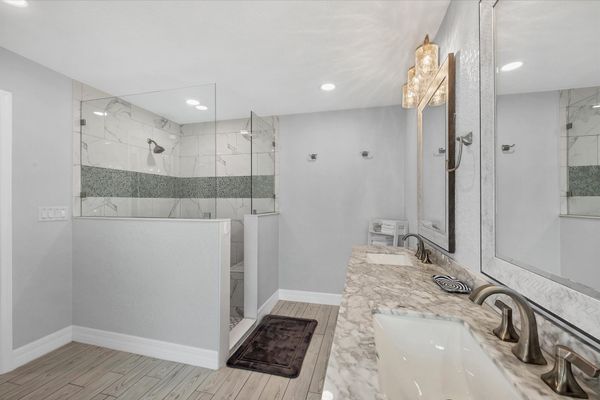 En suite with large walk-in shower, double vanities and soaking tub