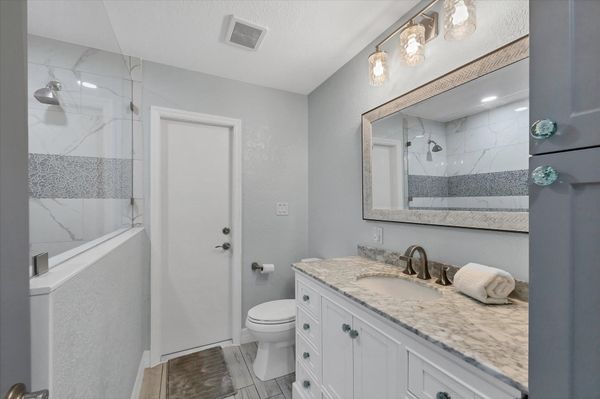 Guest bathroom featuring large walk-in shower