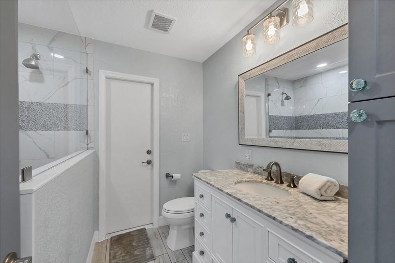 Guest bathroom featuring large walk-in shower