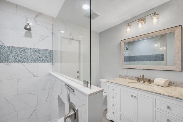 Guest bathroom featuring large walk-in shower