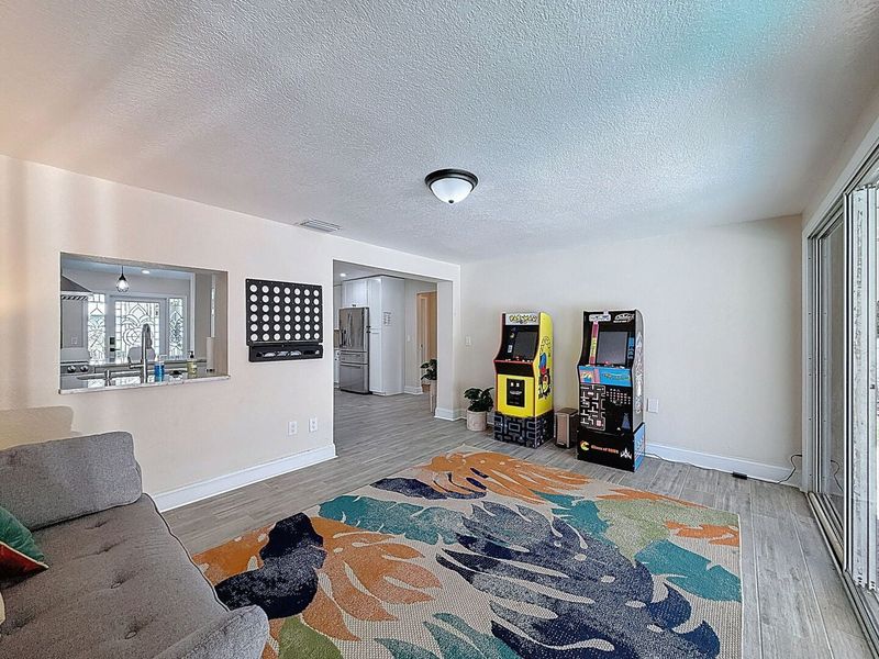 Game Room with 2 arcade games and a sofa sleeper.