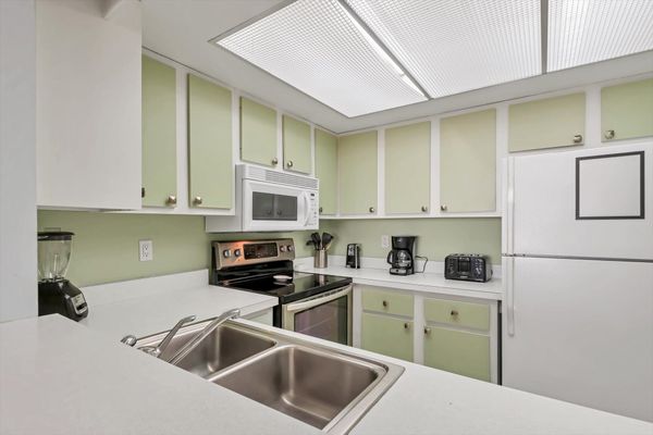 Fully-equipped kitchen overlooking living room/dining room