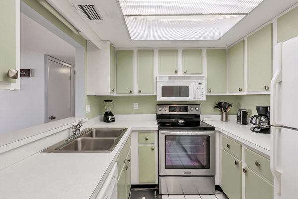 Fully-equipped kitchen overlooking living room/dining room