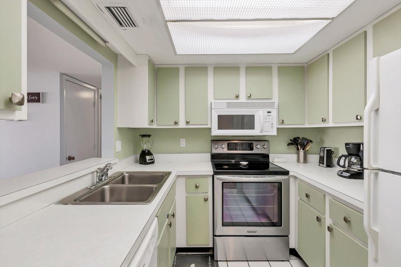 Fully-equipped kitchen overlooking living room/dining room