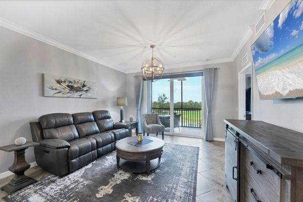 Comfy living room with 65" Smart TV, overlooking the Heritage Landing Golf Course