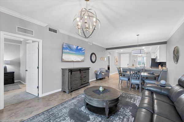 Comfy living room with 65" Smart TV, overlooking the Heritage Landing Golf Course