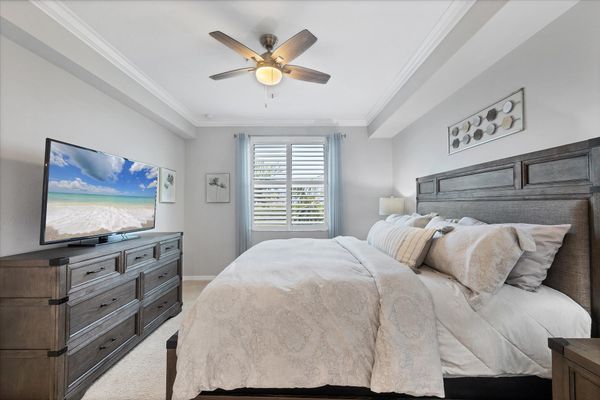 Primary bedroom with king bed and attached bathroom with 55" Smart TV