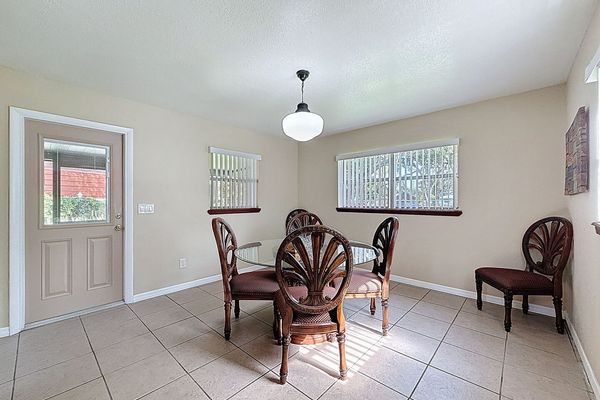Dining Room with door to screened patio and backyard
