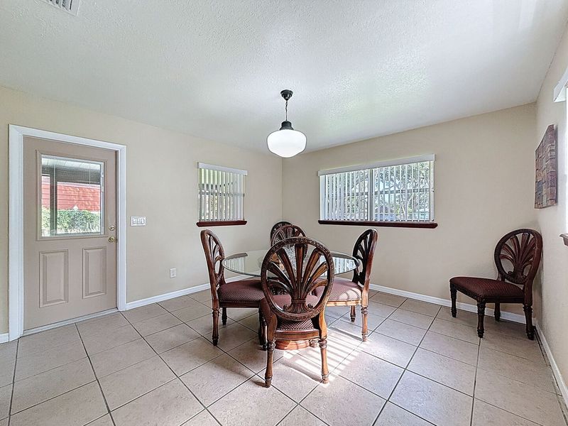 Dining Room with door to screened patio and backyard
