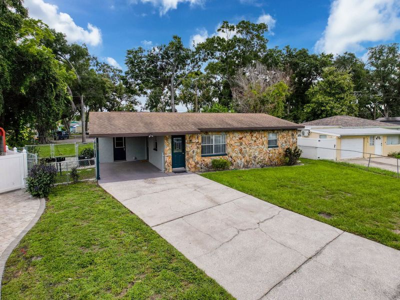 Exterior front with driveway and single car carport