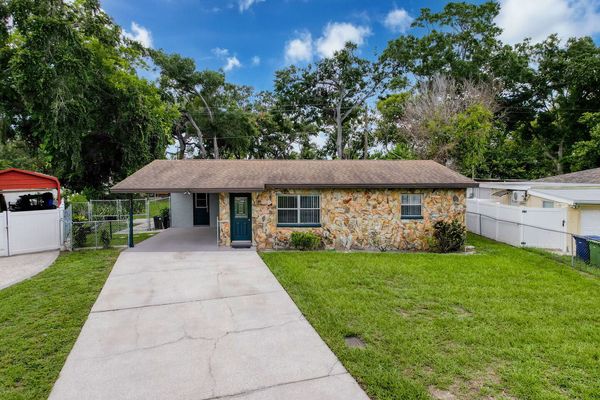 Exterior front with driveway and single car carport