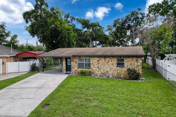 Exterior front with driveway and single car carport