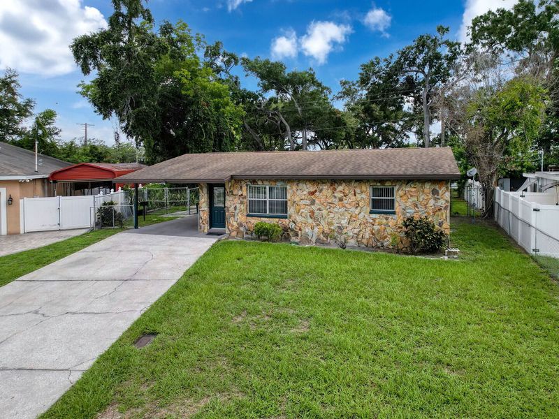 Exterior front with driveway and single car carport