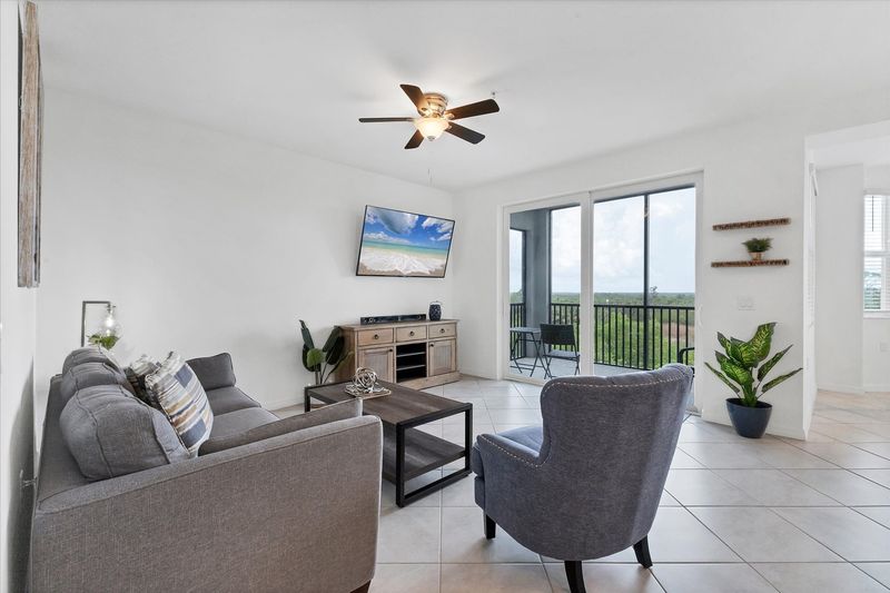 Living room with 55-inch Smart TV, and view of nature preserve