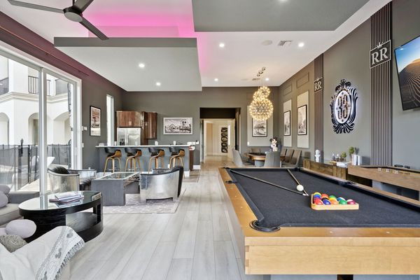 Elegant game room is the perfect retreat for grown-ups. Enjoy a round of billiards, relax in the stylish lounge seating, or sip cocktails at the sleek bar area.