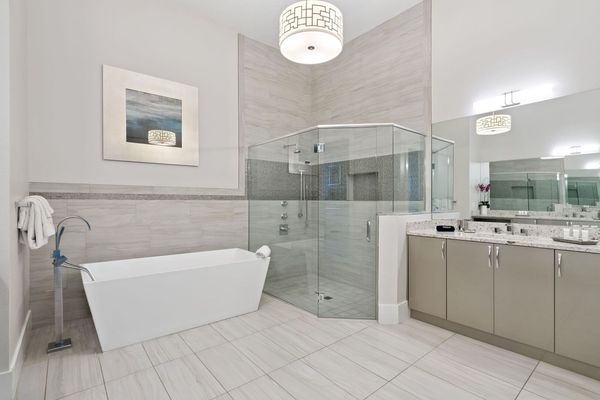 Large en-suite bathroom with glass walk-in shower and garden tub