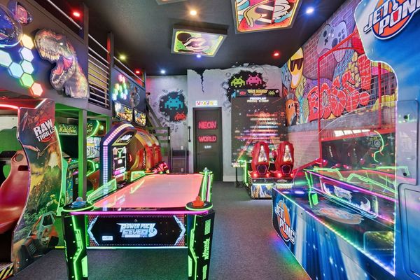 Immerse yourself in a vibrant neon arcade packed with fun for all ages. It's a full arcade experience—right inside your vacation home!