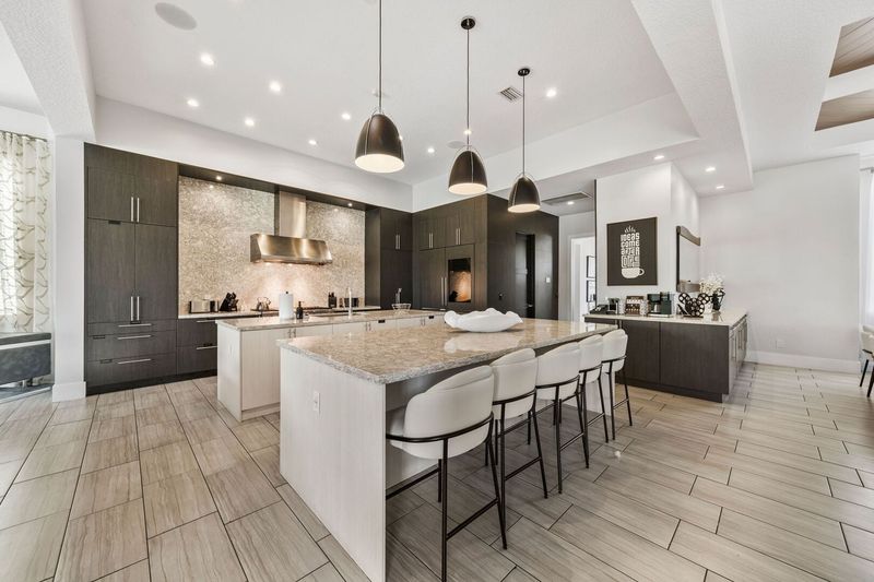 Chef's Kitchen with dual oven and range, dual microwave, dual dishwasher oversized refrigerator, pantry and ample storage