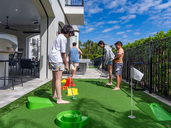 Challenge friends and family to a round of mini-golf on the backyard putting green