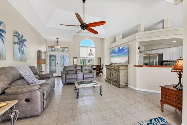 Living room overlooking pool. Living room features plenty of comfy seating and 75-inch Smart TV